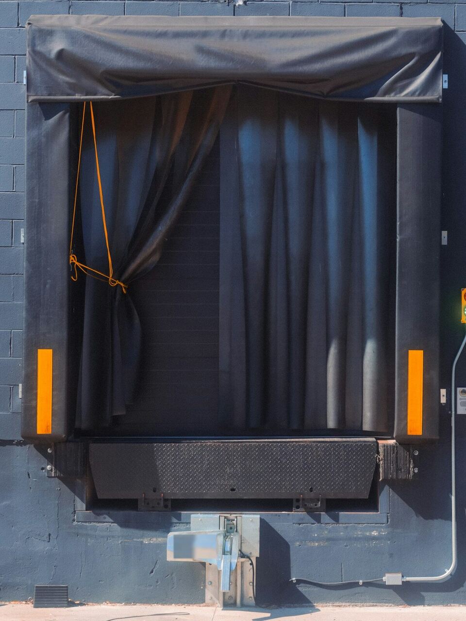 Loading dock door with a dock seal and leveler